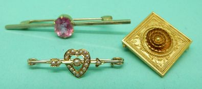 A 15ct gold brooch set with an oval pink stone,