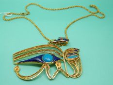 An Egyptian Revival yellow metal pendant set with lapis lazuli,