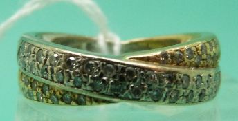An 18ct gold bi-coloured ring set with diamonds in a cross over setting,