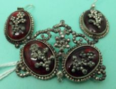 A pair of Victorian earrings set with red foiled cabochons and cut steel floral patterns to the