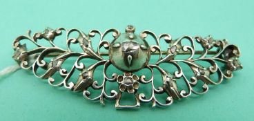A Georgian silver brooch set with rose cut diamonds in a foliate design