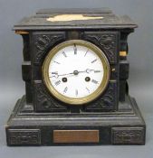 An early 20thC carved wood mantel clock with enamel face with Paris maker's name