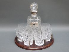 A cut glass whisky set with plated mount to the decanter together on galleried tray,