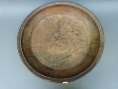 A large treen turned bowl, diameter 56cm and carved oak panel,