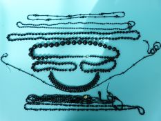 Two carved jet necklaces made up of carved beads,