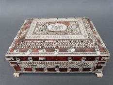 A Vizagapatam jewellery box raised on lions claw feet,