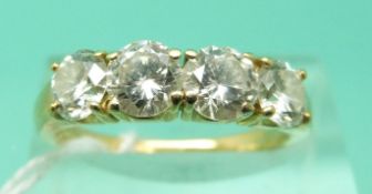 An 18ct gold ring set with four round brilliant cut diamonds, signed Kutchinsky,