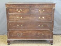A Georgian mahogany chest of two over three graduated drawers with inlaid and reeded column