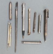 Eight propelling pencils, pencil holders and pens including hallmarked silver,