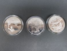 Three silver 40mm diameter coins, comprising Samoa 5 dollars, Marshall Islands 50 dollars,