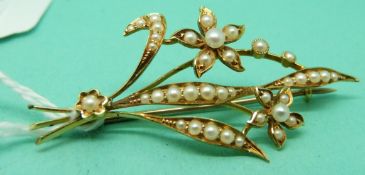 A 15ct gold Edwardian brooch in a floral design set with seed pearls