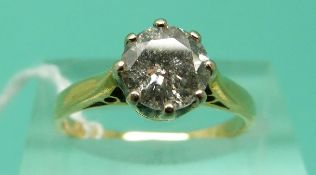 A yellow metal ring set with a round brilliant cut diamond of approximately 0.