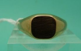 A yellow metal signet ring,