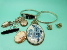A silver filigree pendant set with a Delft plaque, silver and marcasite brooch, silver bangles,