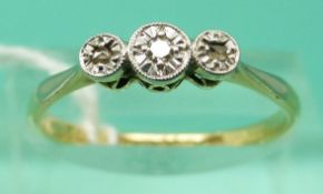 An 18ct gold ring set with three diamonds in a star setting (Size O)