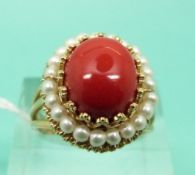 A 9ct gold ring set with a cabochon and faux pearls (Size O)