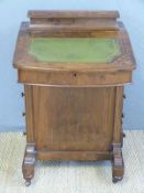 A 19thC walnut inlaid Davenport desk, the lift up writing surface revealing pigeon holes,