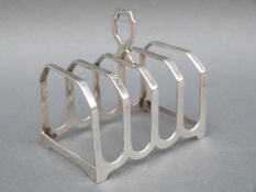 An Art Deco four slice hallmarked silver toast rack, Birmingham 1934 maker Henry Clifford Davis,