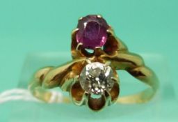 A 14ct gold ring set with a diamond and a ruby (Size O)