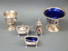 A small collection of silver plated items including cruet set in a small basket