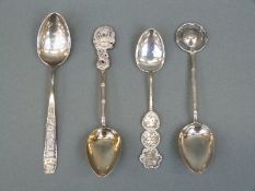Four Chinese and other oriental white metal spoons including a dragon example with silver marks for