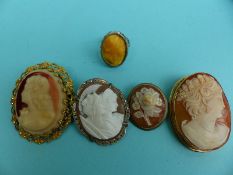A 9ct gold brooch set with a cameo and other cameos