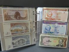 A Numis album containing 100 world bank notes including Central Bank of Egypt, Indonesia, Bahamas,