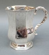 A hallmarked silver octagonal christening tankard with engraved decoration,