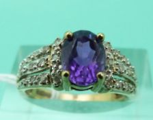 A 9ct gold ring set with an amethyst and diamonds (Size K)