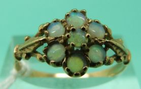 A 9ct gold ring set with opals in a flower cluster (Size R)