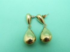 A pair of 9ct gold earrings each made up of two pear shaped drop sections, weight 2.