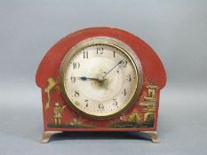 An Art Deco chinoiserie bedroom clock in red lacquered finish depicting oriental scenes