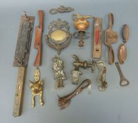 A collection of brass door knockers together with spokeshaves, spirit levels etc.