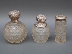 An Edward VII hallmarked silver topped hobnail cut globe shaped dressing table bottle,