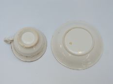 An early 19th century porcelain cup and saucer decorated with flowers,