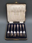 A cased set of six hallmarked silver cake forks Birmingham 1914, maker Charles Wilkes,