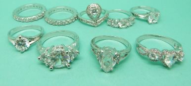 Nine white metal rings marked 10kt set with cubic zirconia