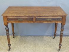 An oak side table with two drawers raised on turned legs,
