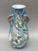 A CH Brannam pottery vase with dragon handles and impressed marks to base FB,
