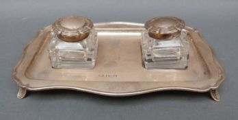 An Edward VII hallmarked silver double desk inkwell with silver topped cut glass bottles both