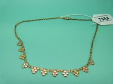 A 9ct gold tri-coloured necklace with diamond shaped sections, 11.5g.