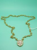 A Kutchinsky 18ct gold necklace made up of knotted gold sections with a circular cluster pendant