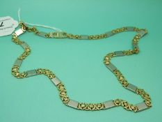 A bi-coloured necklace made up of rectangular links and circular links marked 585, 65.