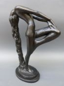 A black statue of a girl with flowing hair,