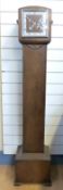 A c1930 oak cased granddaughter long case clock with two train movement and utility Roman dial,
