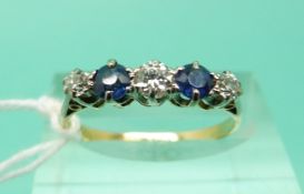 An 18ct gold ring set with alternating diamonds and sapphires (Size N)