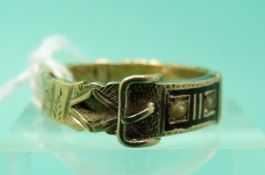 A 9ct gold Victorian mourning ring in the form of a buckle set with sections of plaited hair,