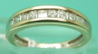 An 18ct gold ring set with 10 princess cut diamonds, total diamond weight approx 0.