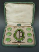A cased hallmarked silver and guilloche enamel buckle and stud set,