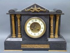 French 19th century black slate mantel clock decorated with Romanesque columns with battle scene